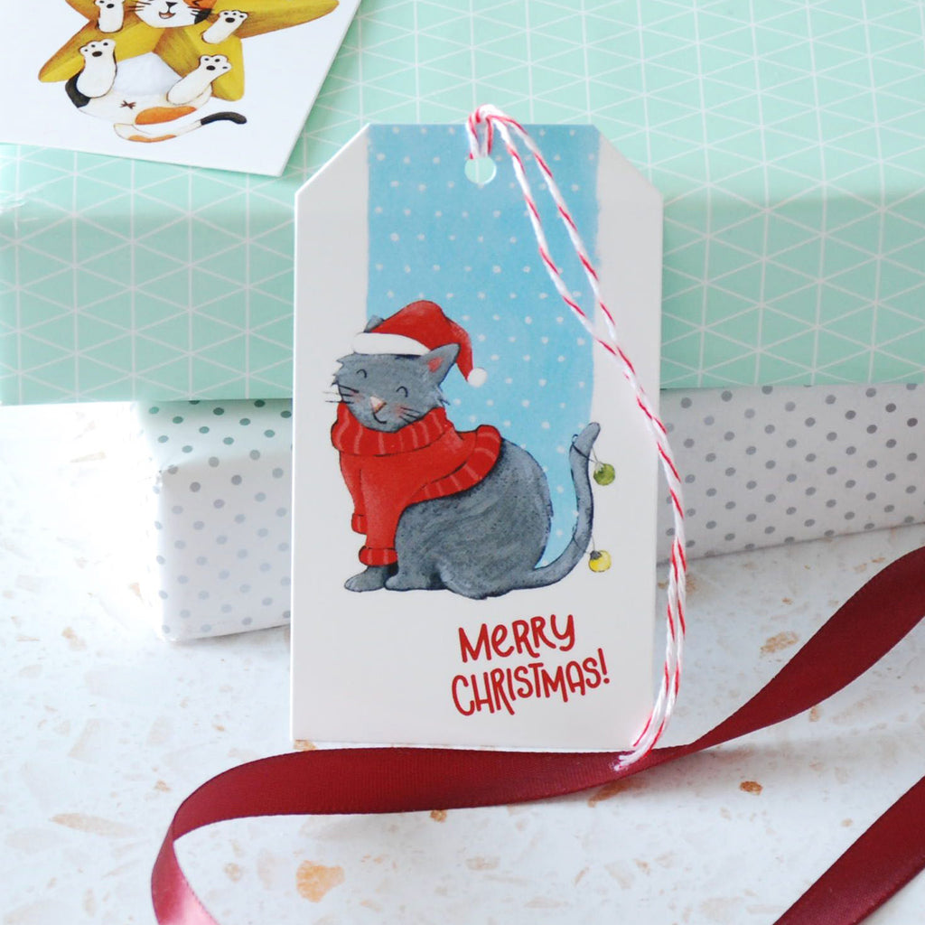 grey cat in red sweater and hat holiday gift tag w/ message Merry Christmas