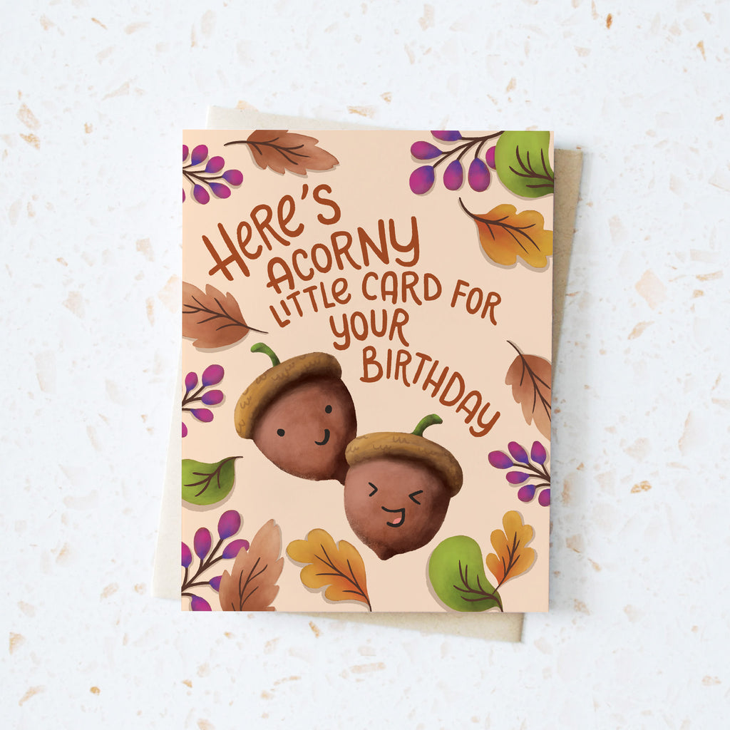 fall leaf pattern background with two laughing illustrated acorns