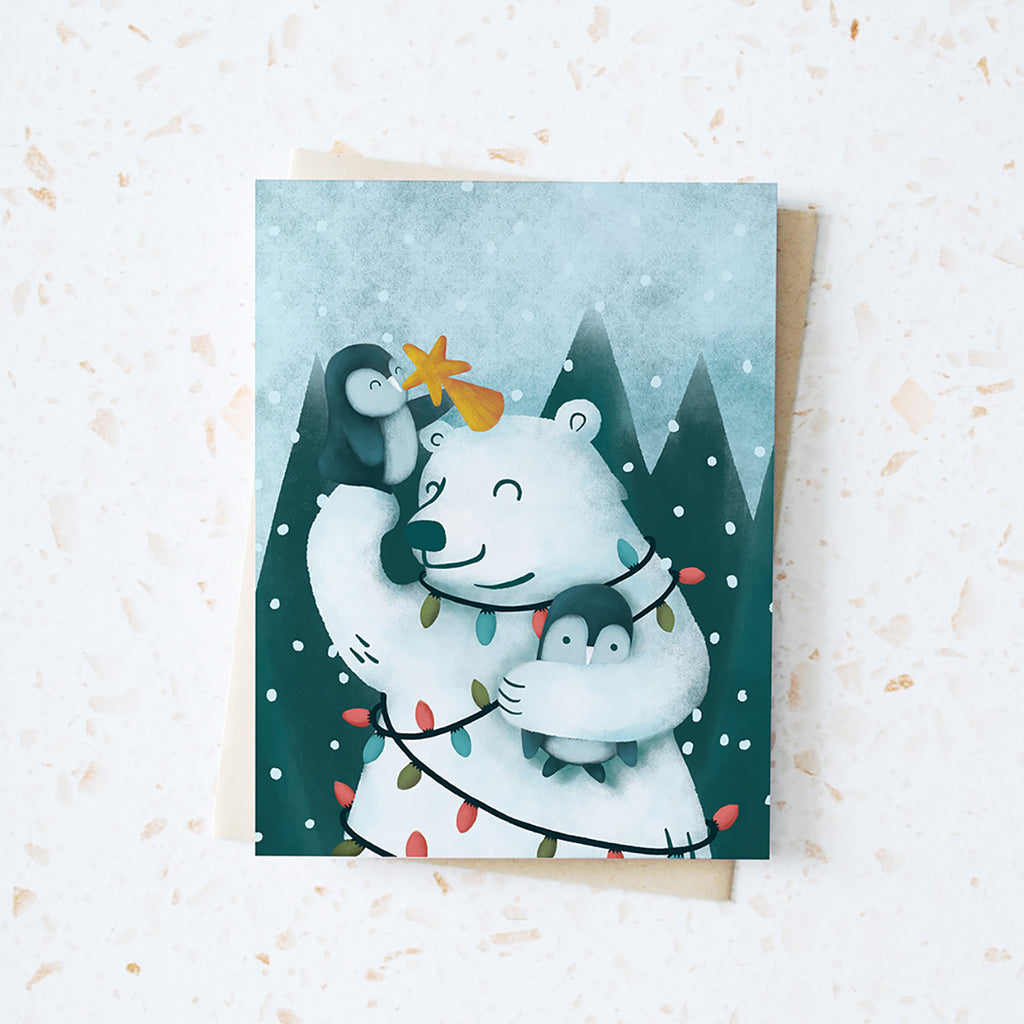 Penguins adding a yellow star on top of polar bear for christmas