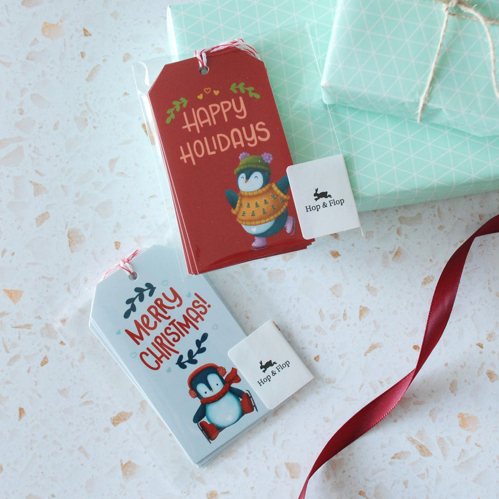 Set of 6 cute penguin skating gift tags with message, Happy Holidays and full red background
