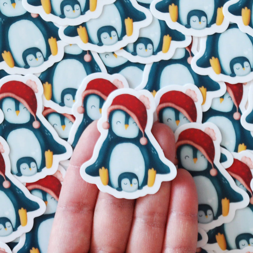 A pile o' cute mini penguin momma cuddling her baby vinyl sticker