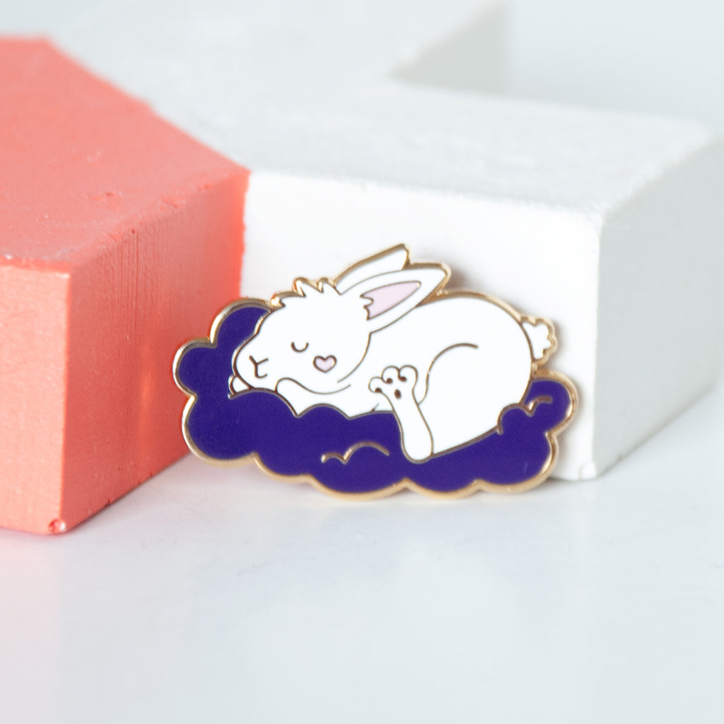 Sleeping white bunny on a fluffy purple cloud enamel pin