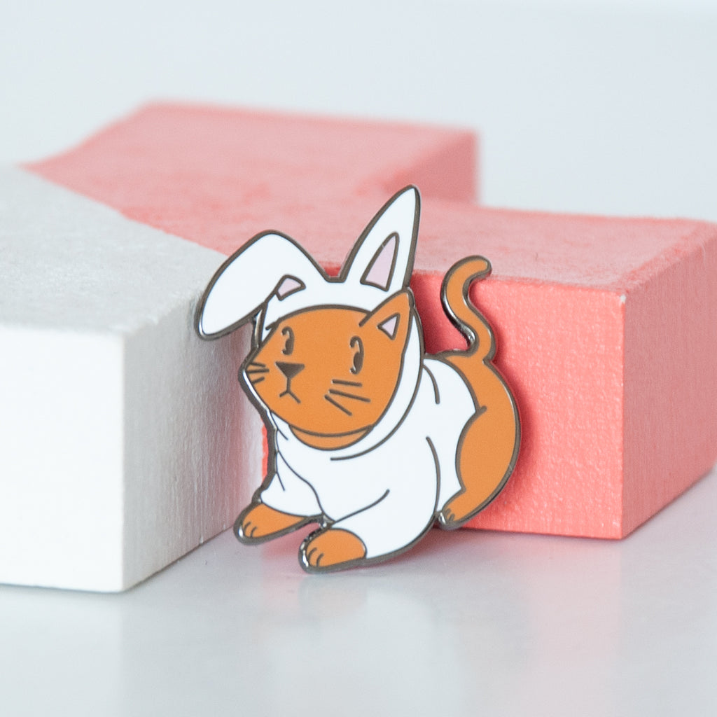 Cosplay ginger cat in a white bunny outfit hard enamel pin