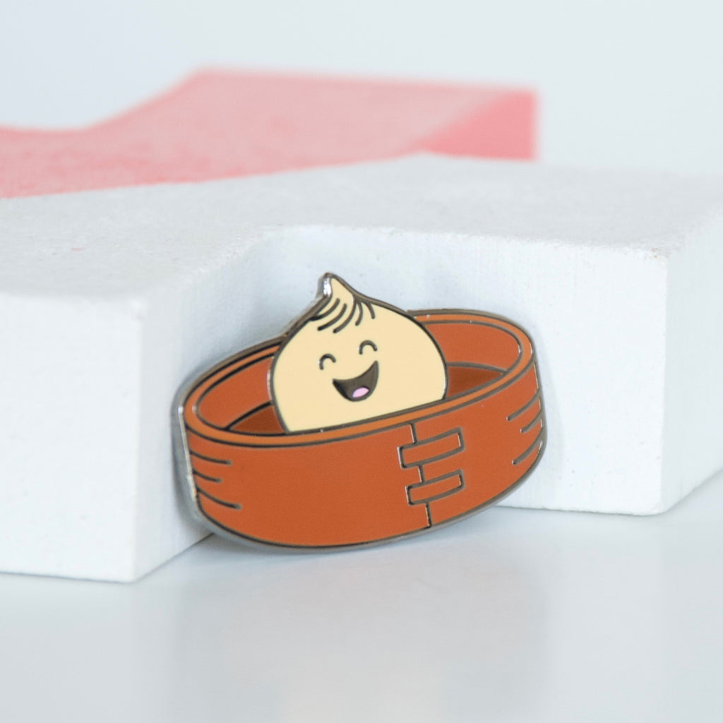 Asian Dumpling or Bao in a bamboo steamer basket hard enamel pin. 