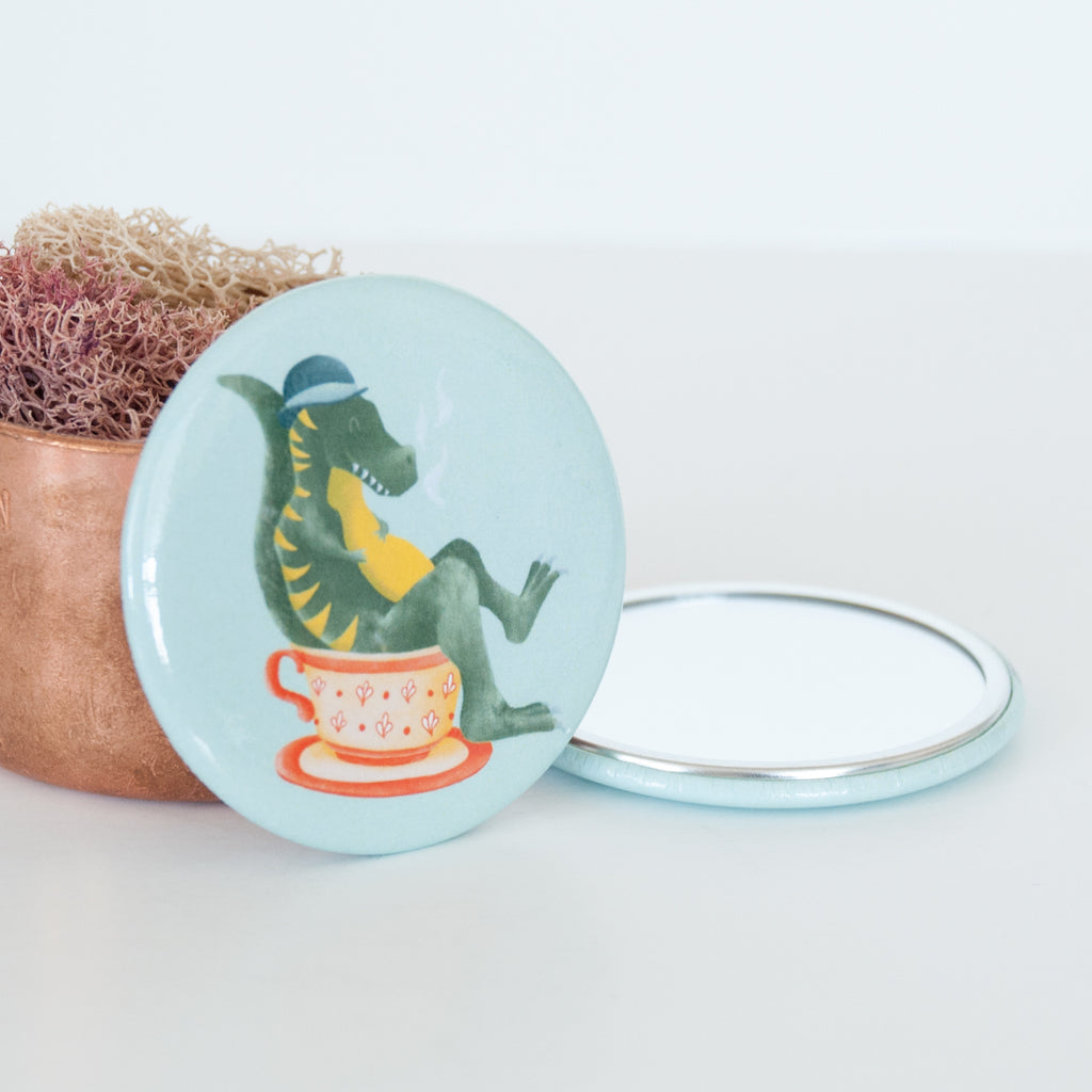 T Rex sitting in a Tea cup illustrated travel pocket mirror